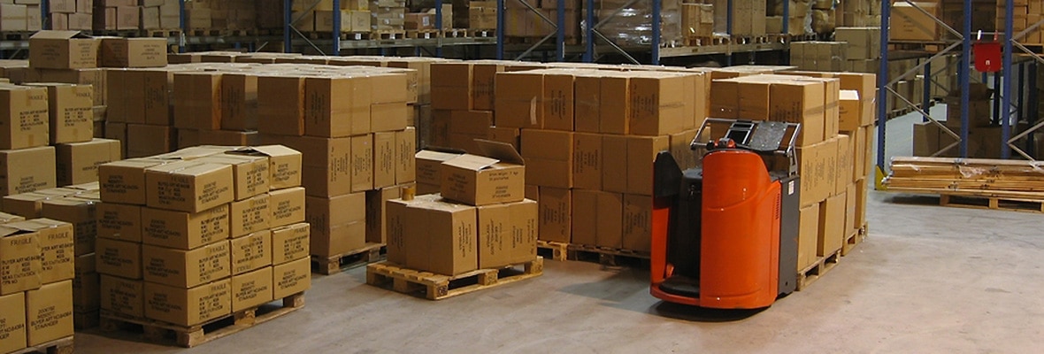 Warehouse with boxes, pallet lifter and shelving